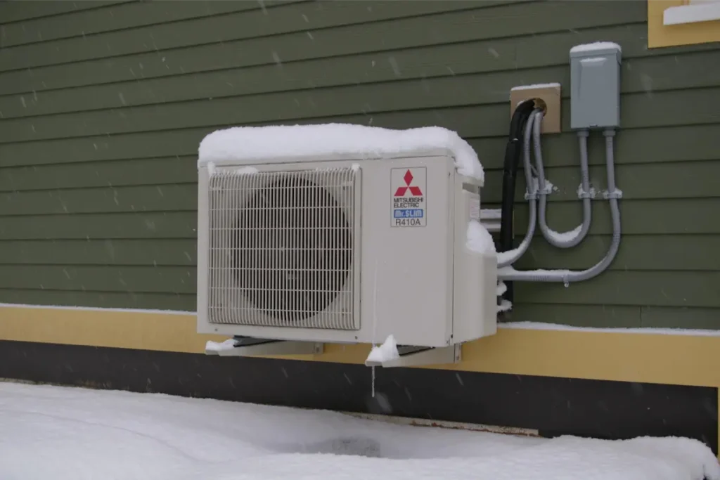Mitsubishi cold-climate heat pump operating in snowy conditions
